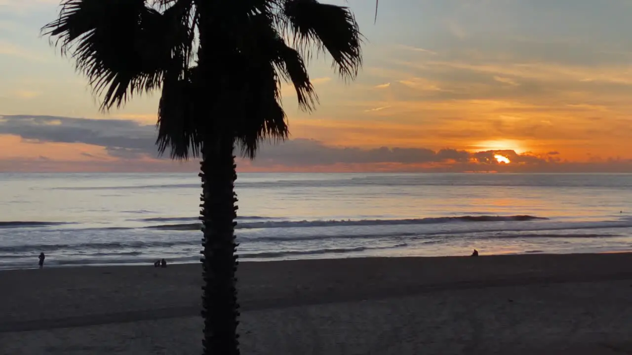 silhouette of a some surfers against the sun during the sunset Carcavelos beach