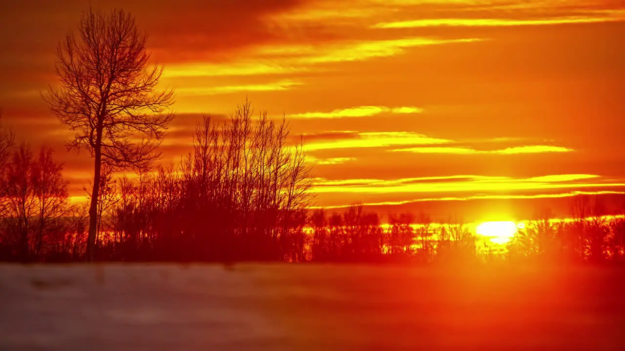 Golden glowing sunset on a snowy winter landscape time lapse