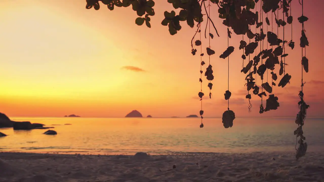 4K UHD Cinemagraph of a mobile gently swinging in the wind at a beach on Perhentian Island Malaysia by sunset