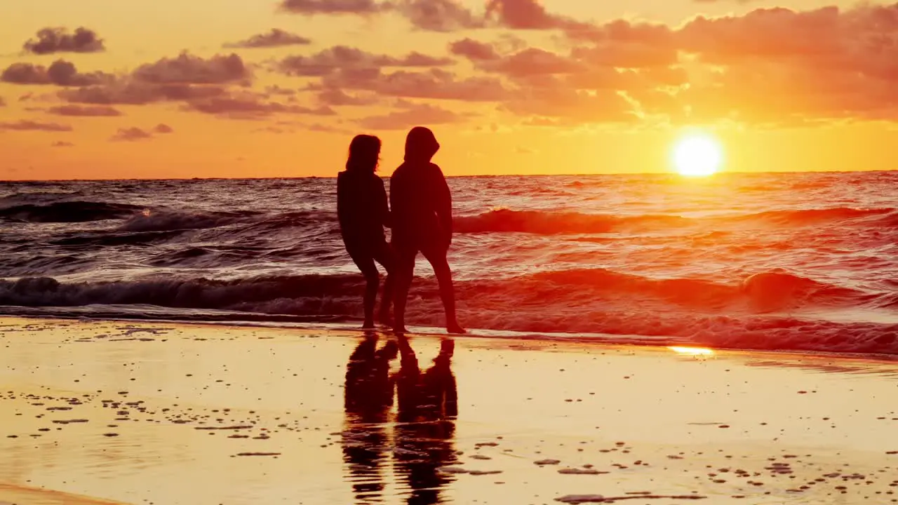 Two Young Girls Watching Sunset on Beach