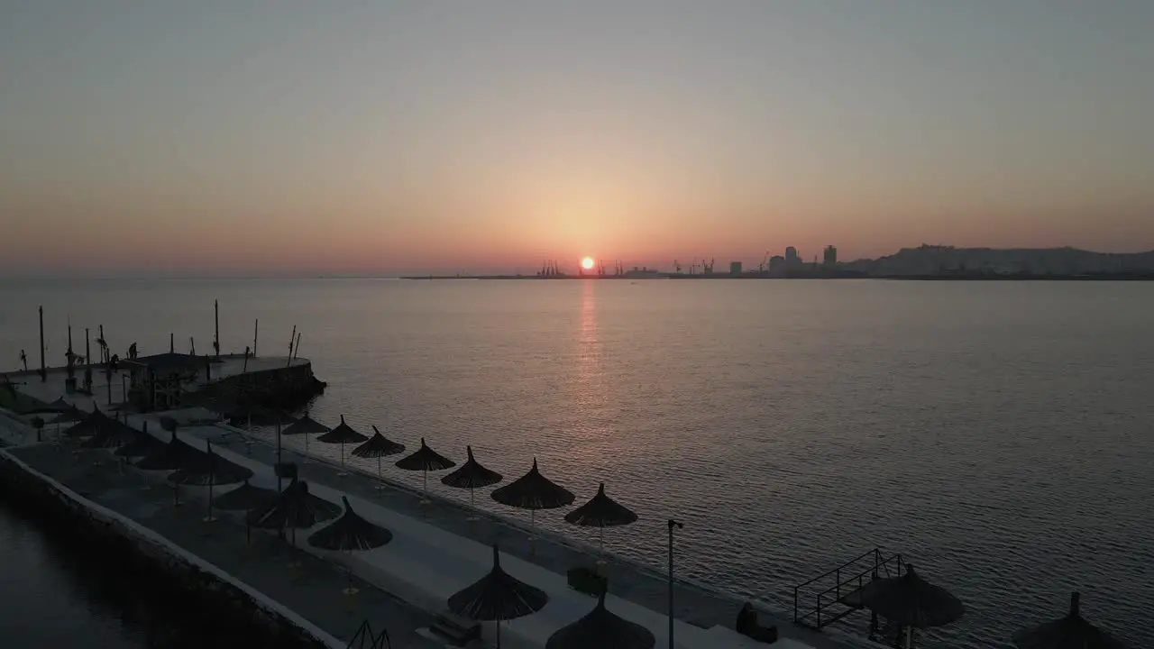 Sunset aerial flyover Public jetty on Adriatic Sea in Durres Albania