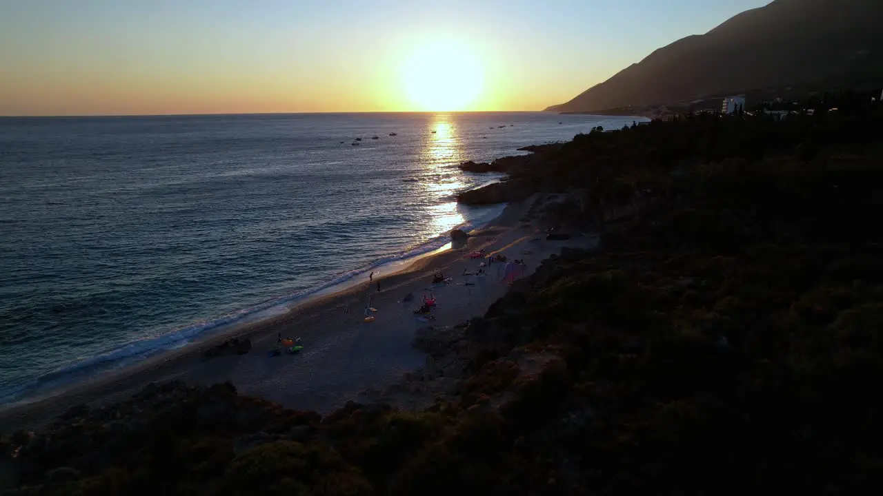 Sunset at Drimadhes beach sun reflecting on sea water romantic evening in Mediterranean coast