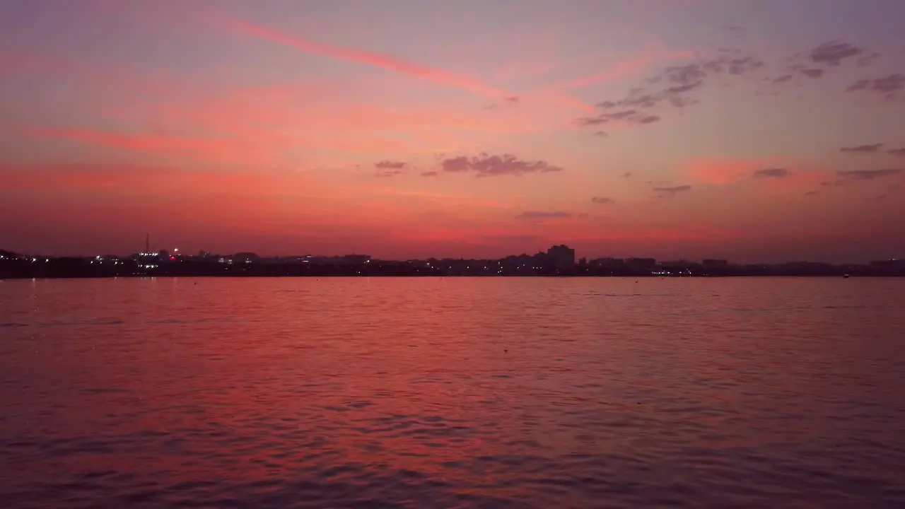 A Colorful Scenic View of Lake in the City During Sunset