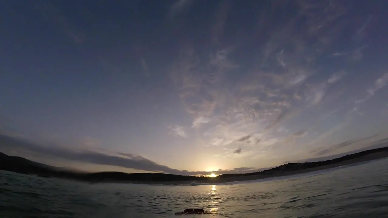 Surfer showing an amazing sunrise with go pro