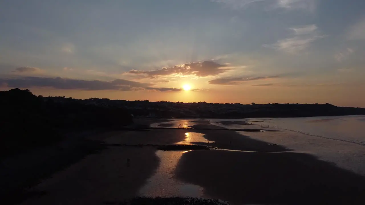 Golden heavenly sunset rays aerial view reflected over romantic exotic beach coastline moving forwards