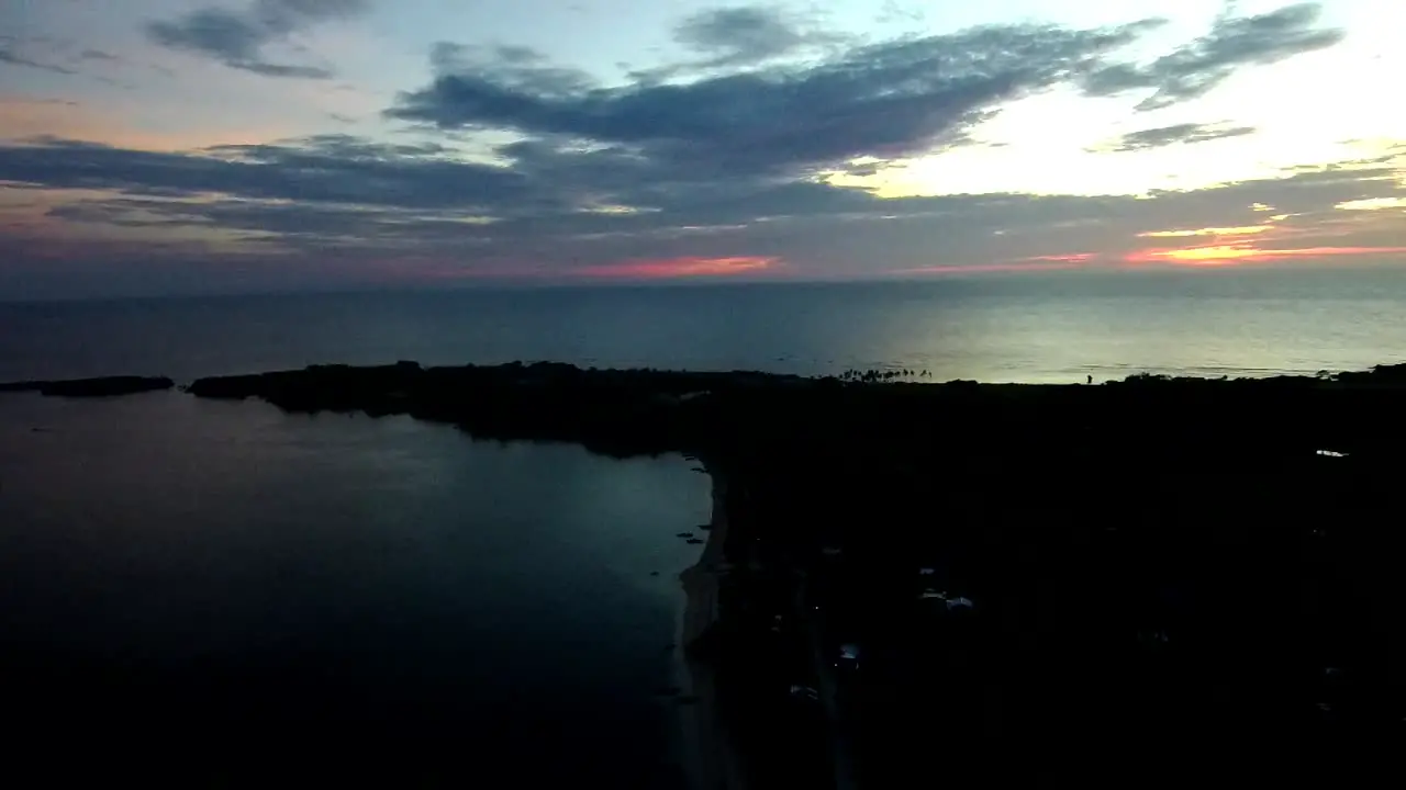 Cinematic aerial footage of a white sand beach in a tropical island in the Philippines taken during a sunset