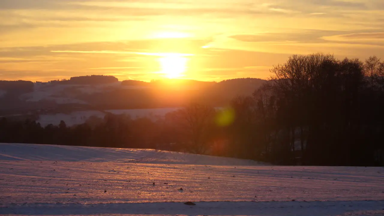 Breathtaking orange sunset with a wonderful winter landscape in upper austria