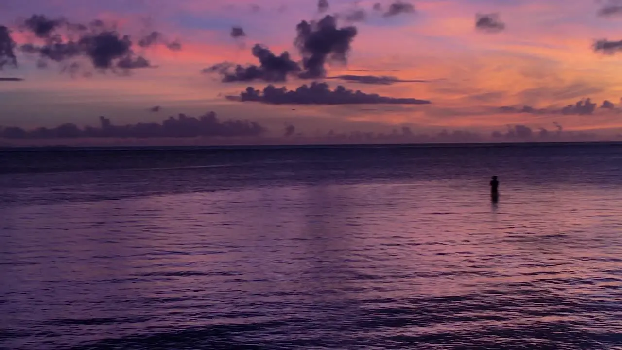 Graphic Purple Sunset with Silhouette of lonely fisherman in riviera