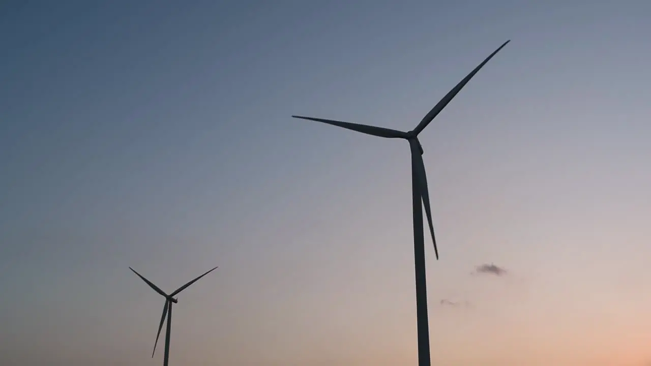 Wind Turbines Silhouette against the Blue-sky during Sunset clean alternative energy in Thailand and mainland Southeast Asia