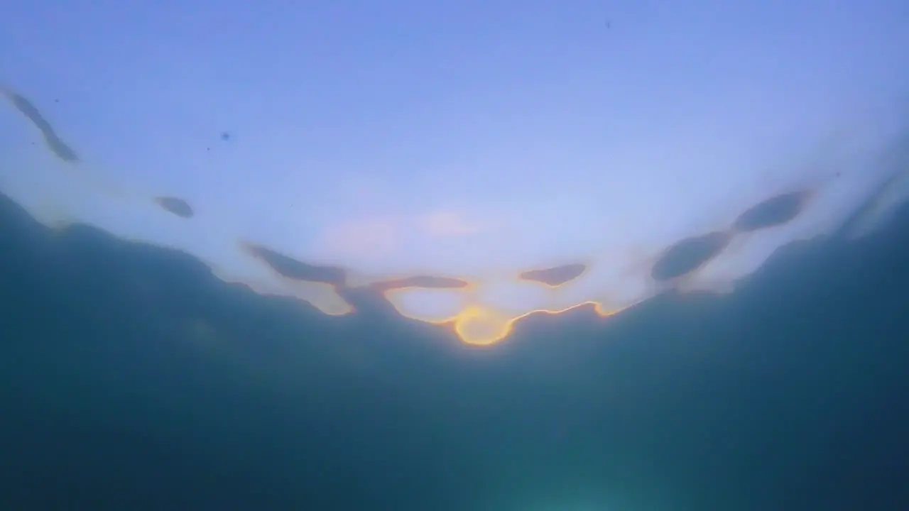 sunset from under water with abstract water ripples and beautiful color pattern