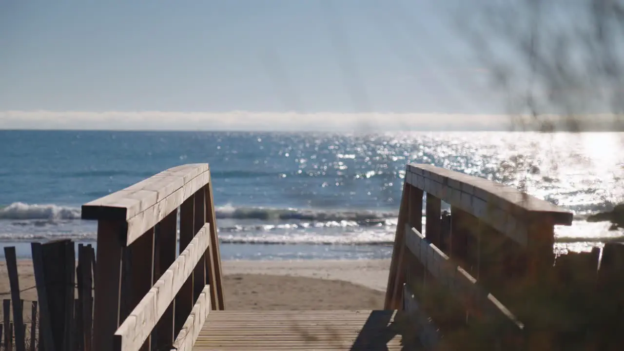 Change of focus between a bridge leading to the beach and the sea