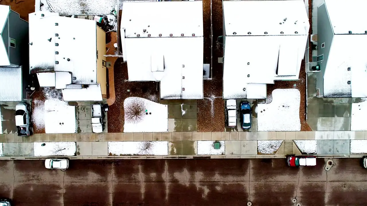 Snowy roofs from a late March storm all lined up in this 4k drone shot