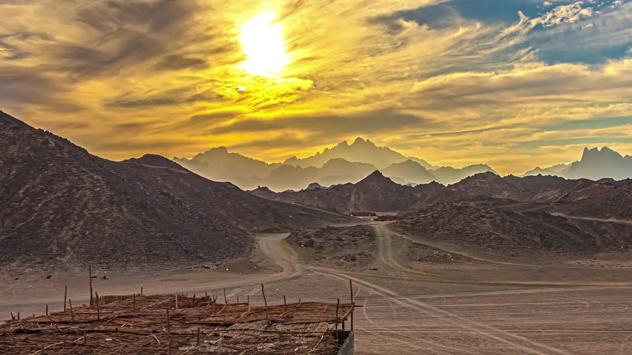 Golden clouds timelapse in Egypt at sunset with mountains and moving car