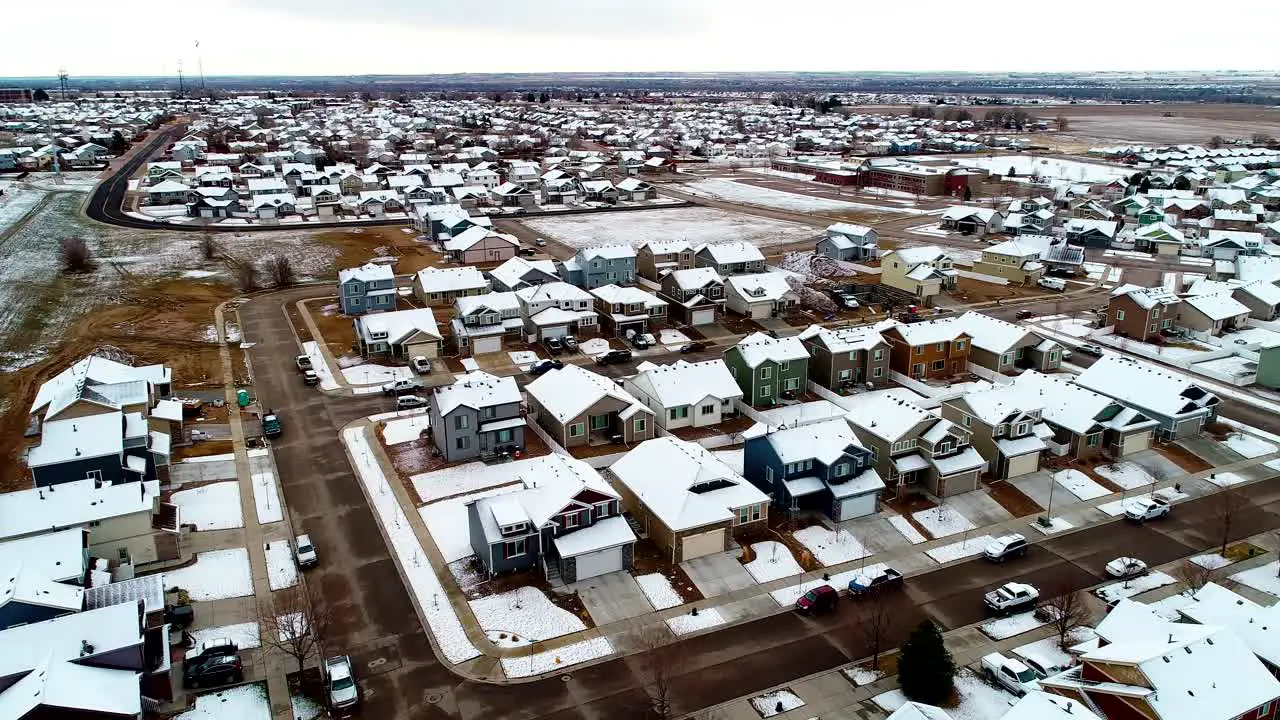 Cold snow covers the rooftops in this suburban neighborhood in late March before the spring season begins