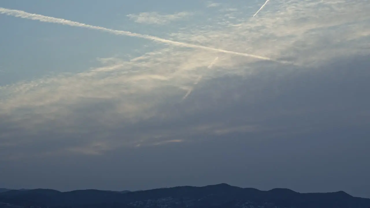 time lapse that captures ever-changing sky as grey clouds move in covering morning sun