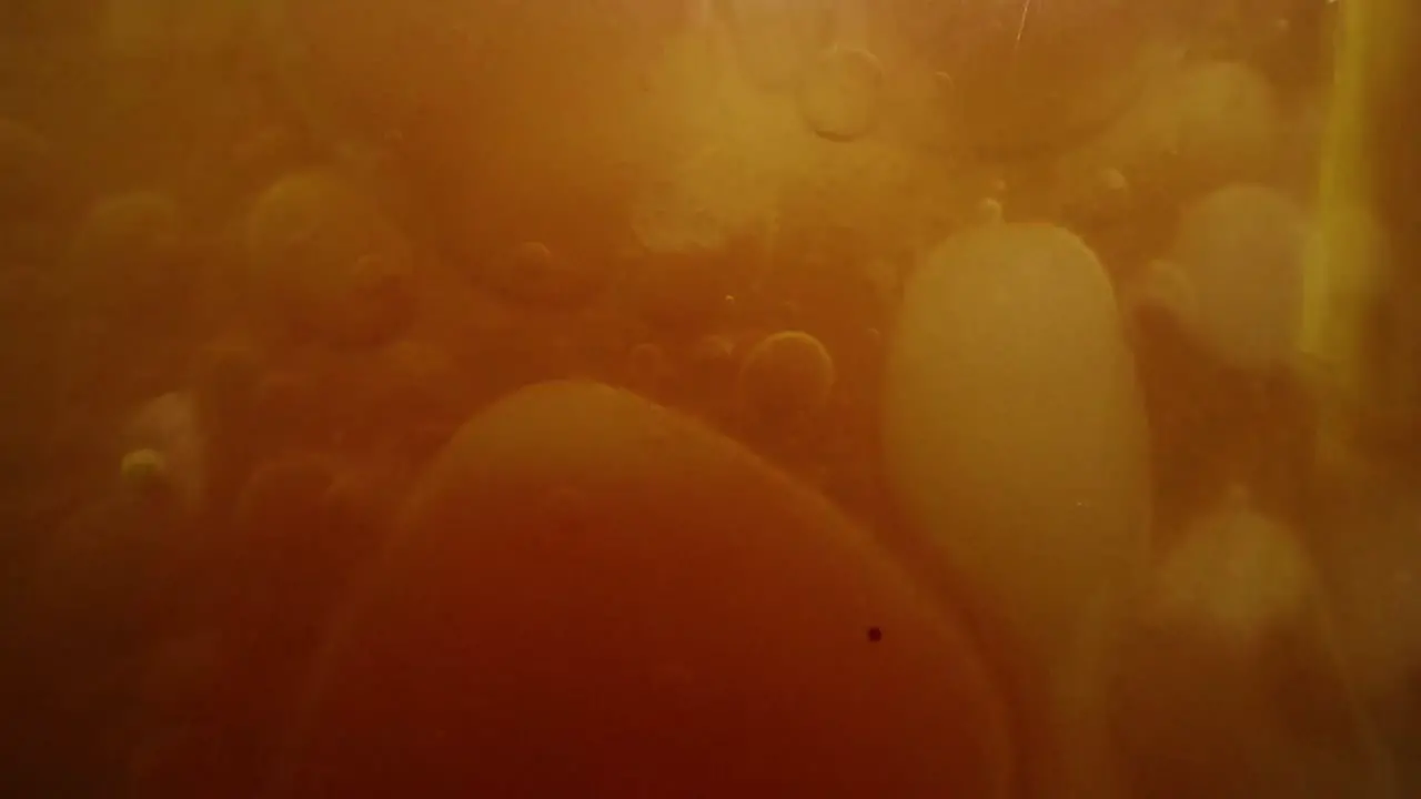 Yellow and red bubbly liquid inside a tank in a laboratory