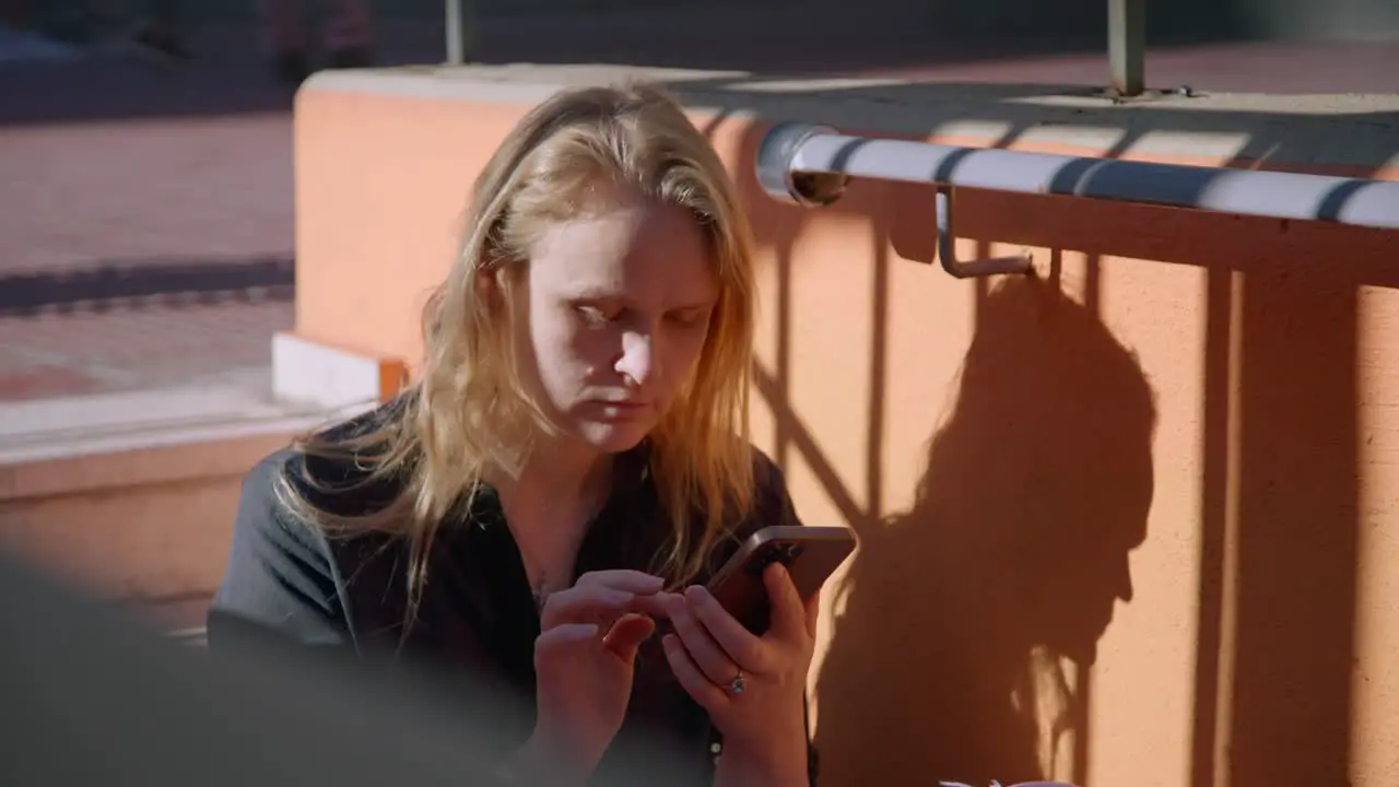 A woman with a mobile phone on the street