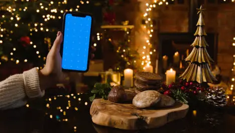 Christmas At Home With Traditional German Christmas Lebkuchen And Person With Blue Screen Mobile Phone 3