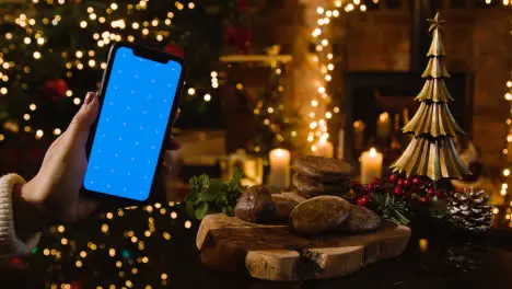 Christmas At Home With Traditional German Christmas Lebkuchen And Person With Blue Screen Mobile Phone 2