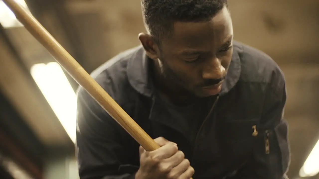 Janitor dancer looks down as he mops slow motion close up