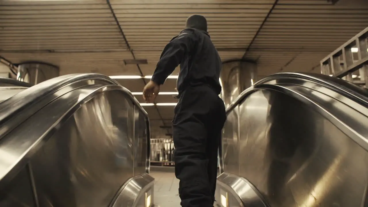 Janitor dancer runs off of escalator and spins off steadicam medium close