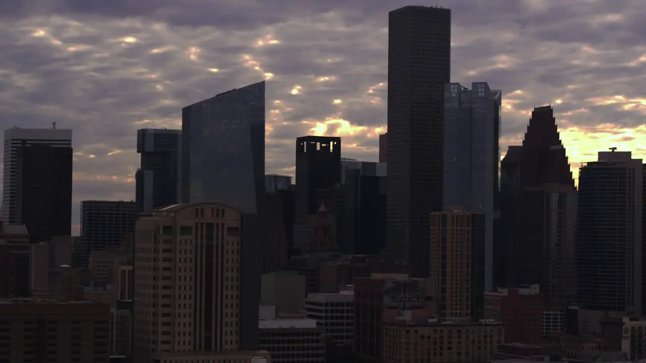 Tracking left aerial shot of downtown Houston during sunset