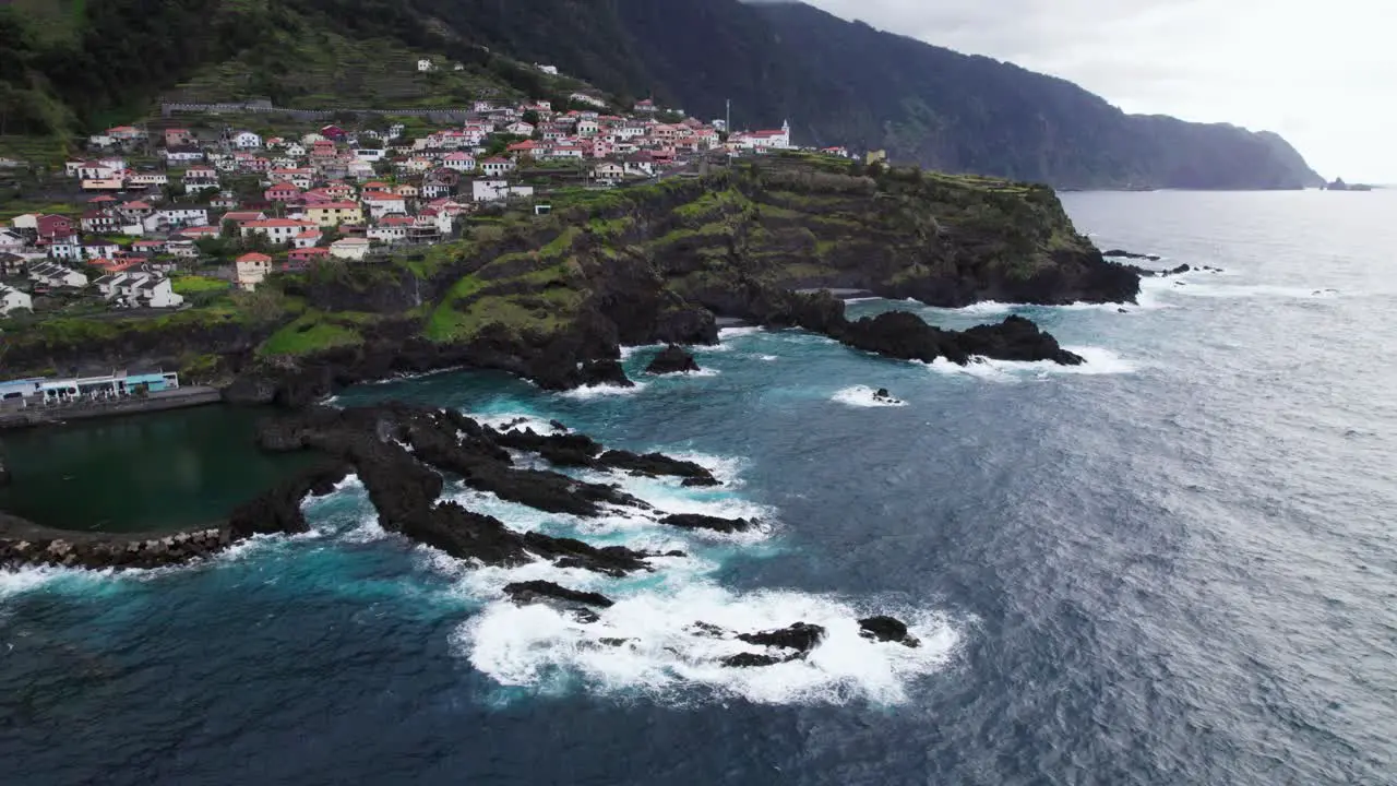 Rocky cliffs and small town Madeira Portugal drone aerial