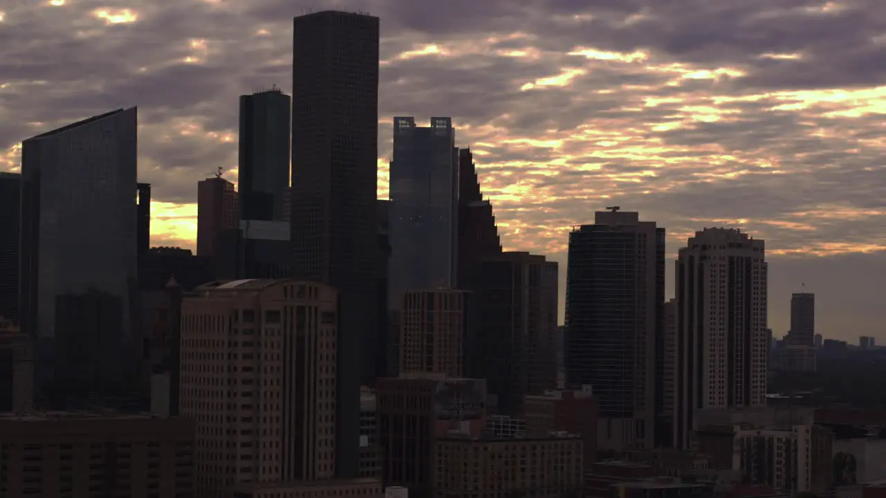 Drone dolly shot moving forward away from downtown Houston Texas during sunset