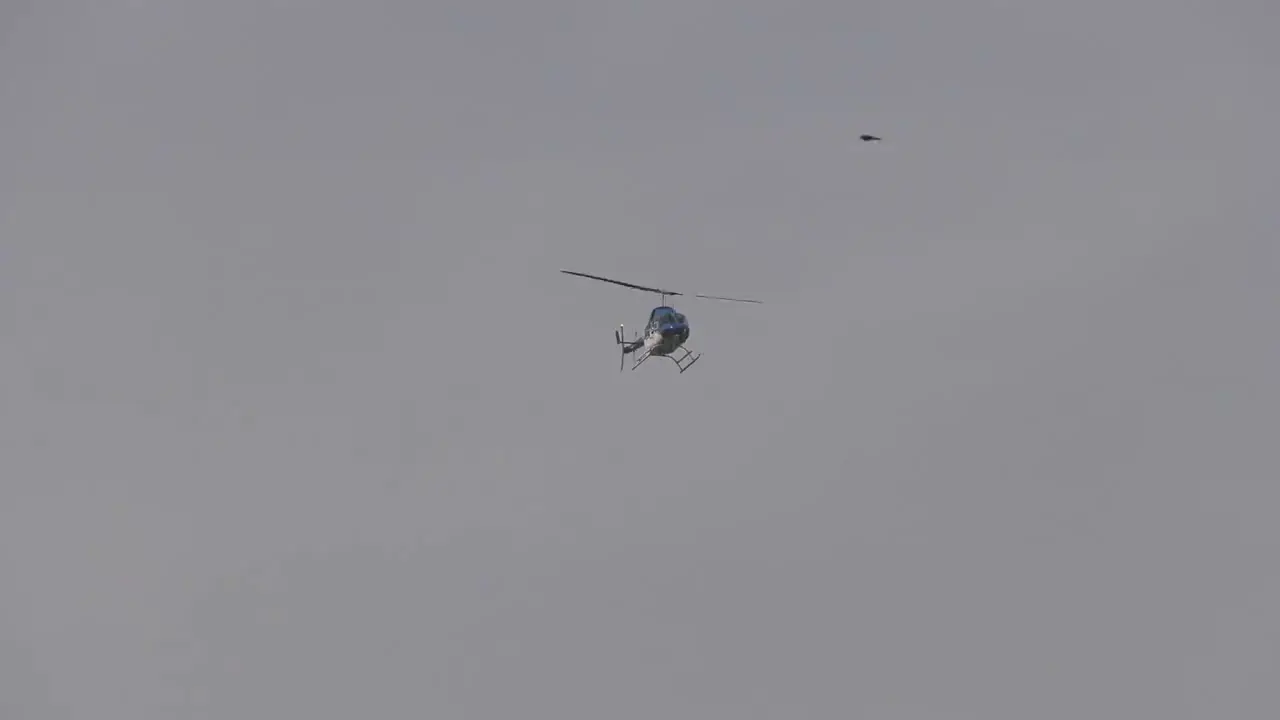 Helicopter flies over on cloudy day