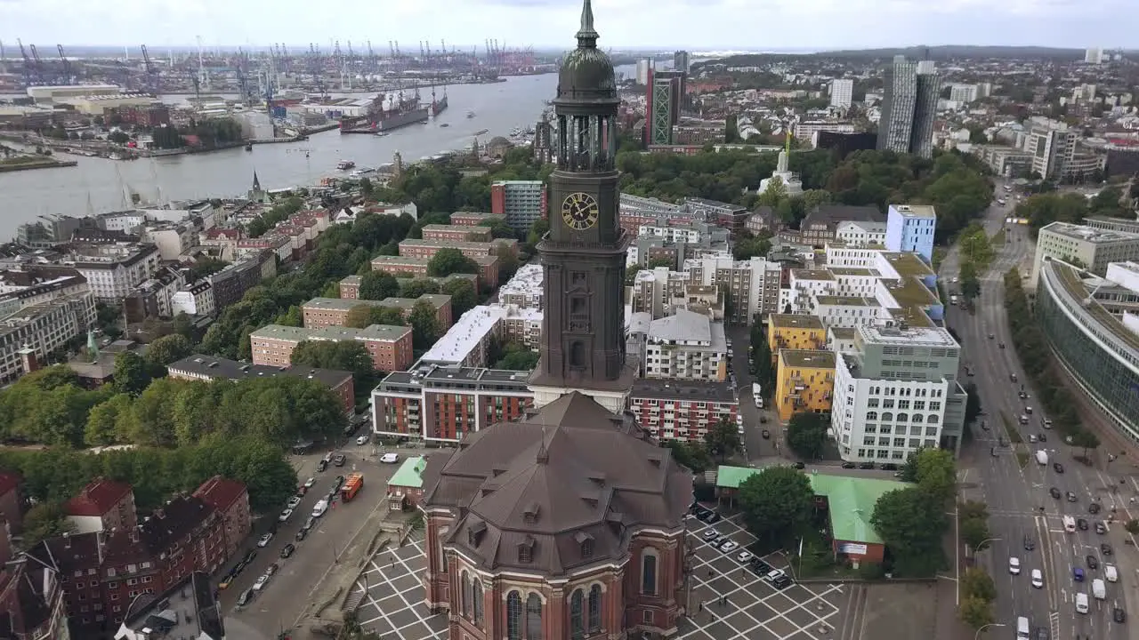 flying towards church in hamburg city germany gaining hight tilting camera down