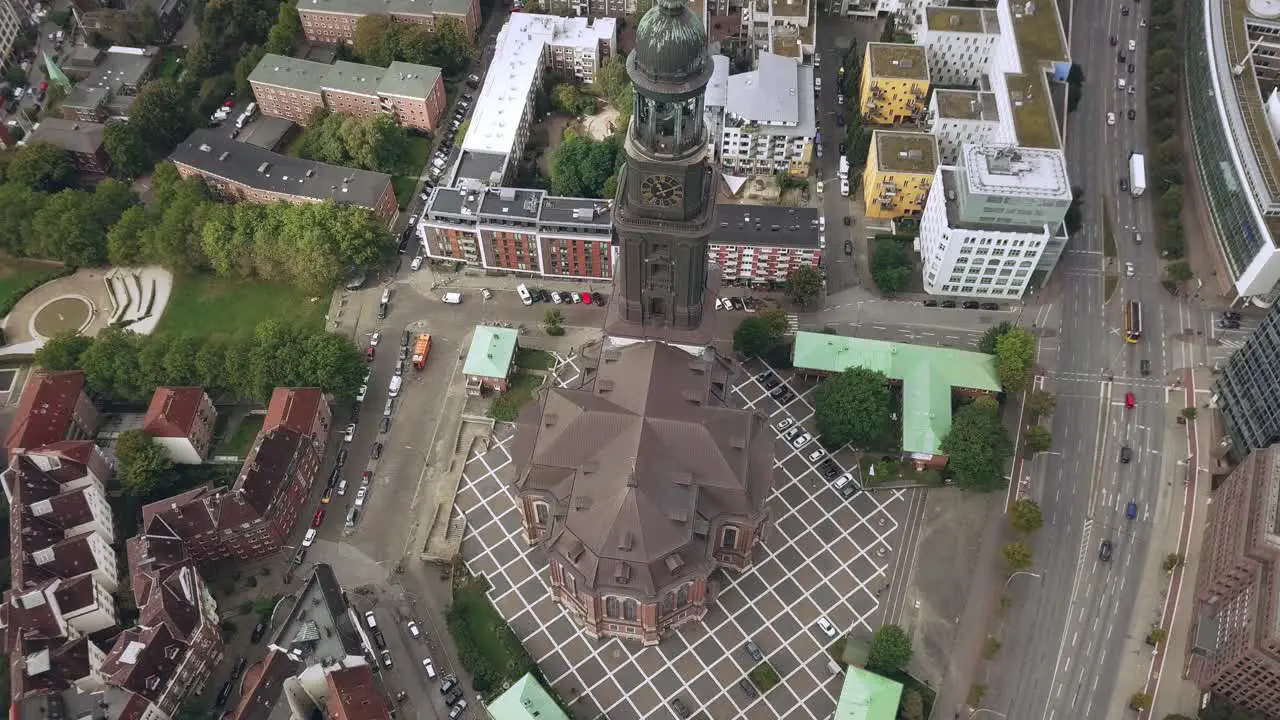 flying above a church in hamburg city germany gaining hight tilting camera down