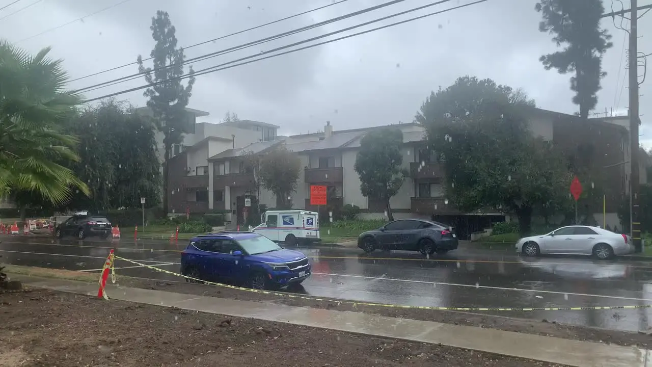 rain falling on busy residential street