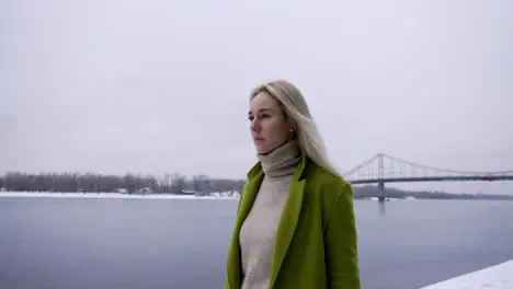 Sad woman walking near the lake