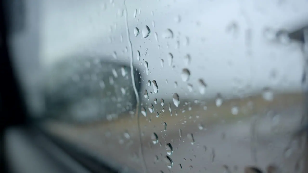 Mirror of car in rainy day drops of water in car glass