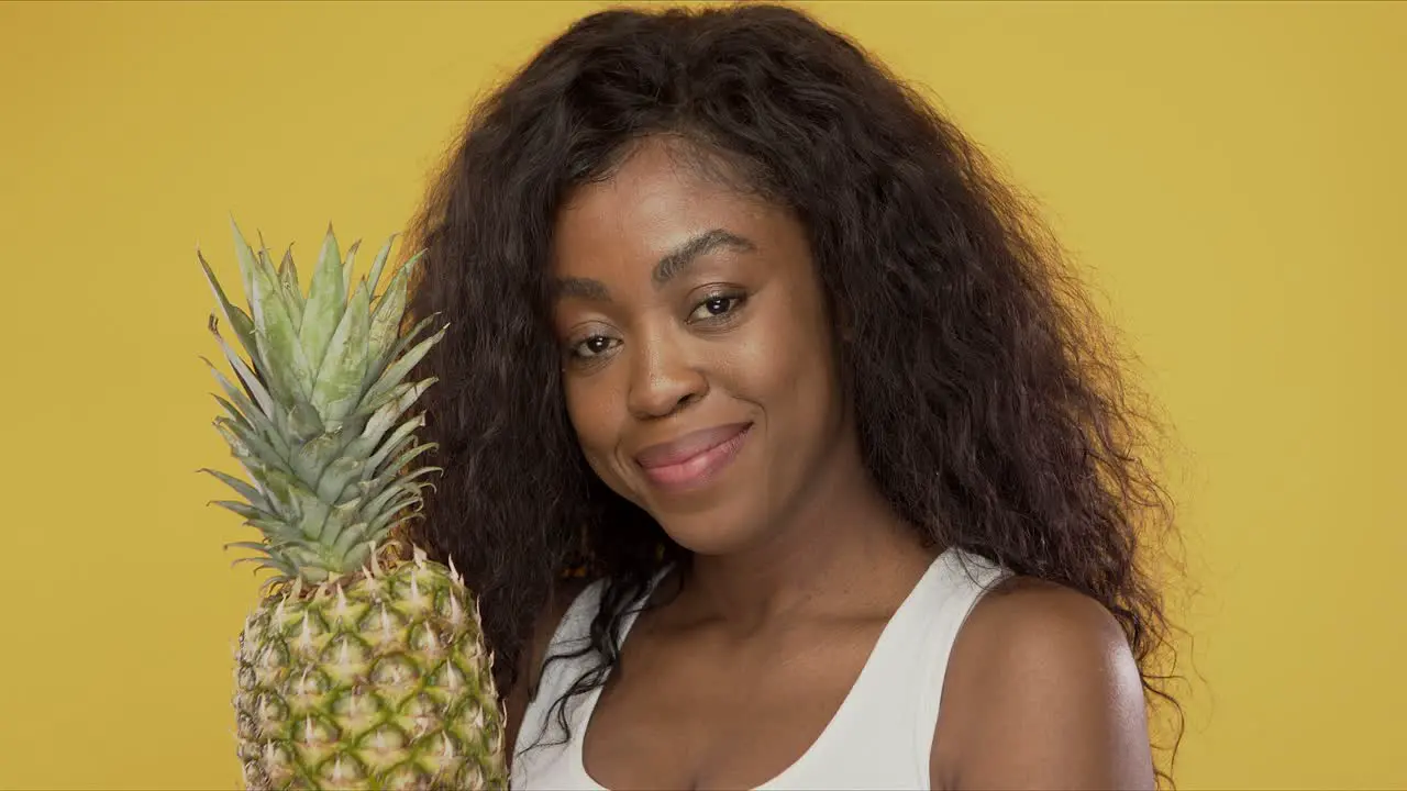 Positive woman with pineapple