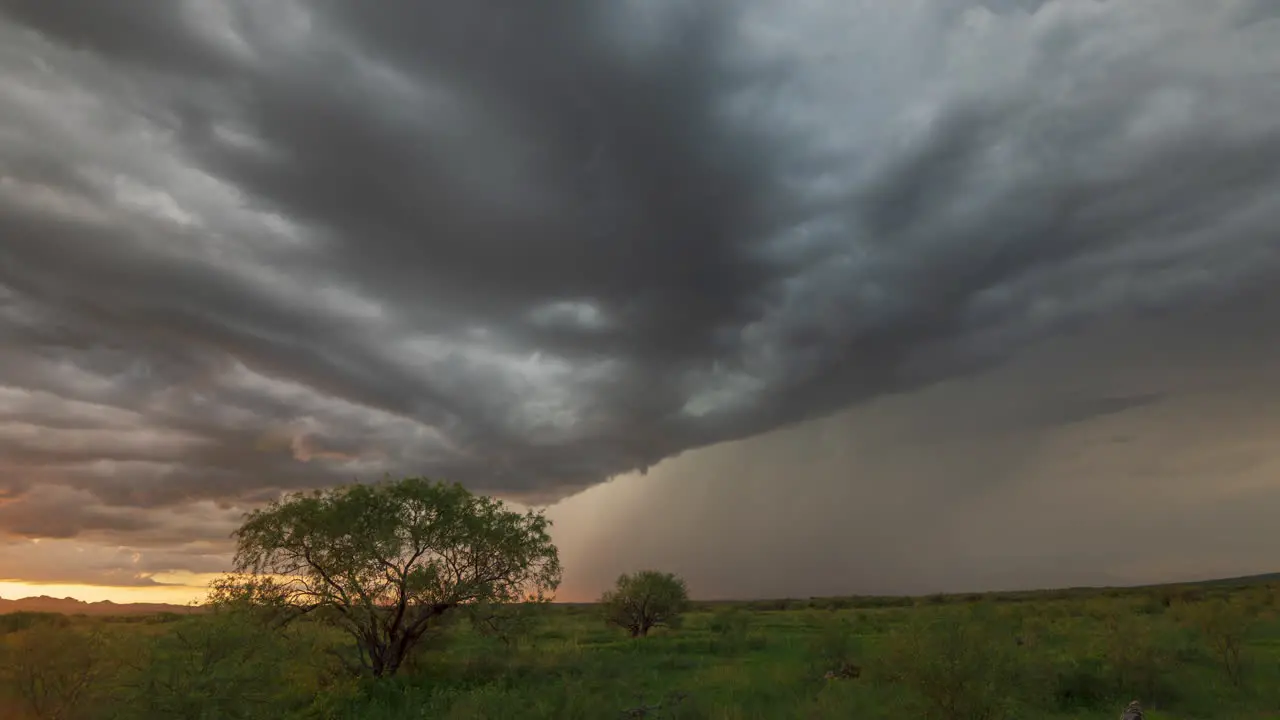 Dramatic dark clouds over trees and fields with lightening bolts