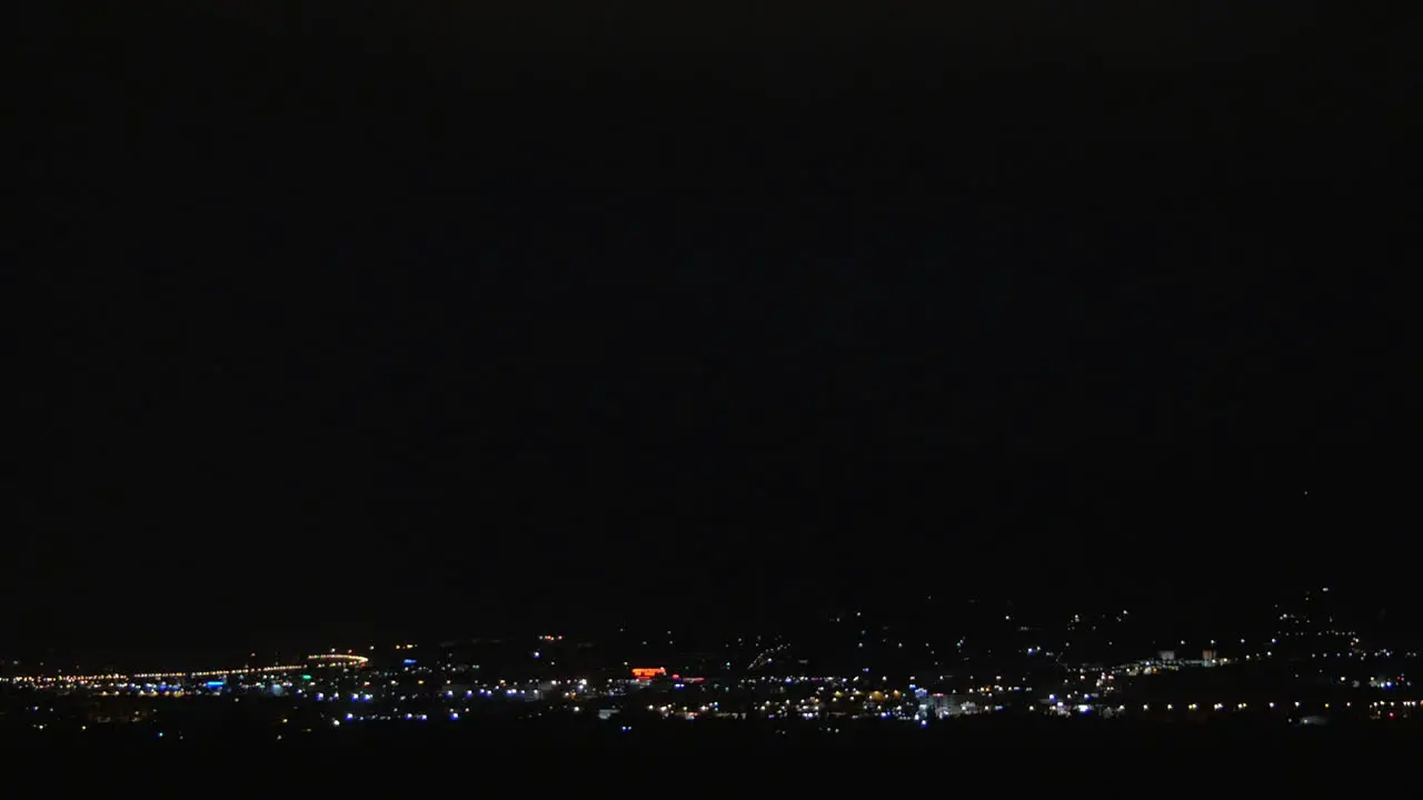 Thunderstorm in night illuminated city