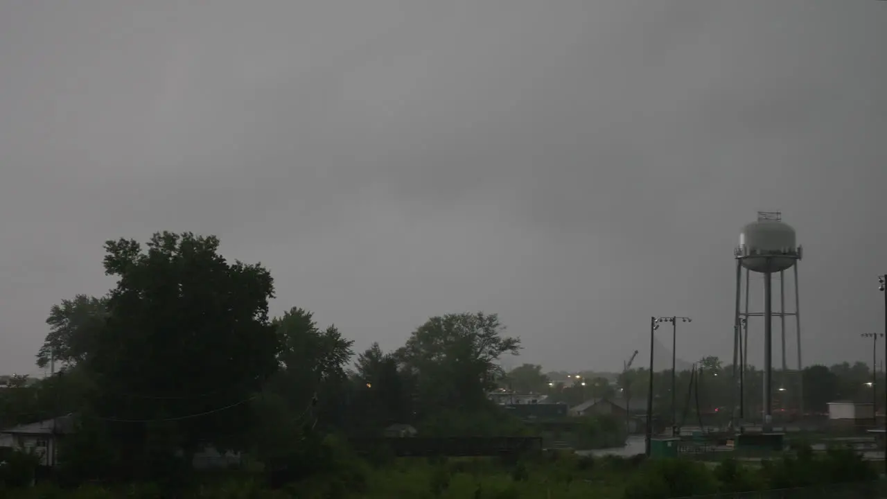 Timelapse of a water tower and creek in a thunder storm