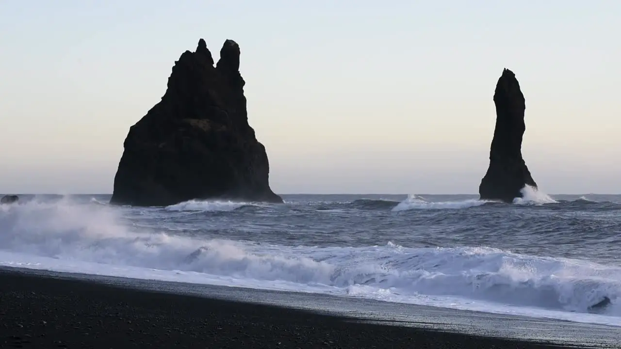 A Rough winter sea with waves crashing on a black beech near Vik in Iceland