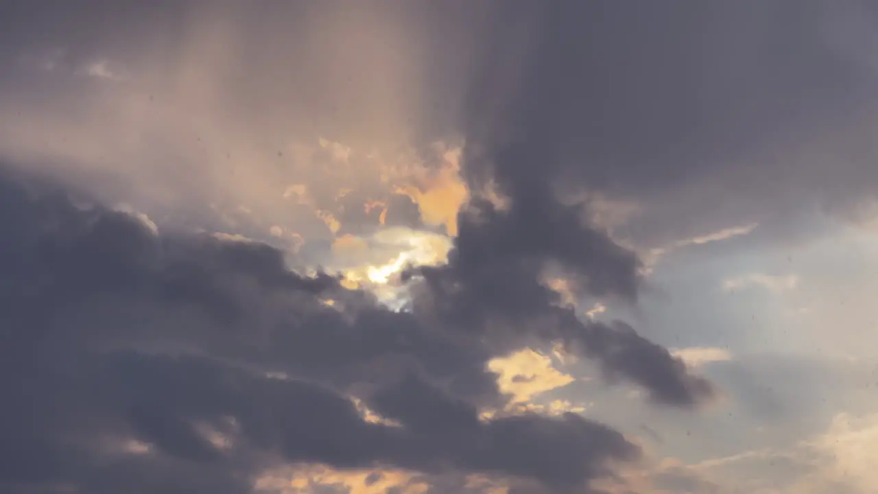 Sunlight beaming through heavy storm rainy clouds