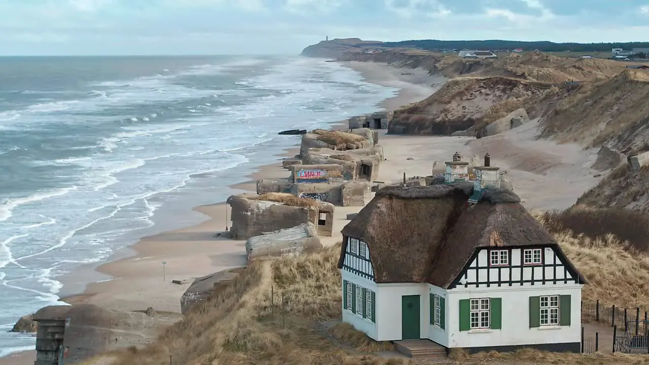 Danish house at the beach with bunkers in the backround shot by drone