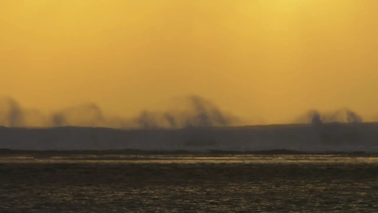 Slow motion view of ocean waves against yellow red sunset sky Mauritius Island