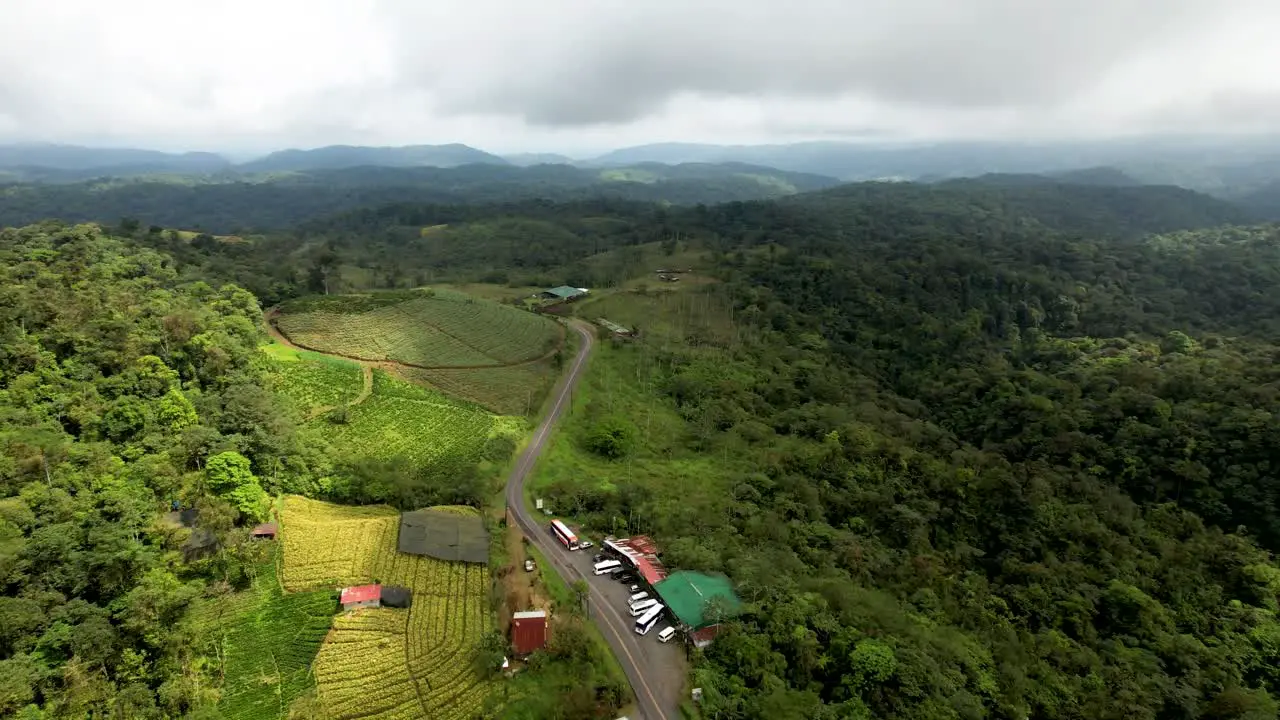 Costa Rican Farmland in Rainforest jungle with cloudy sky- Aerial