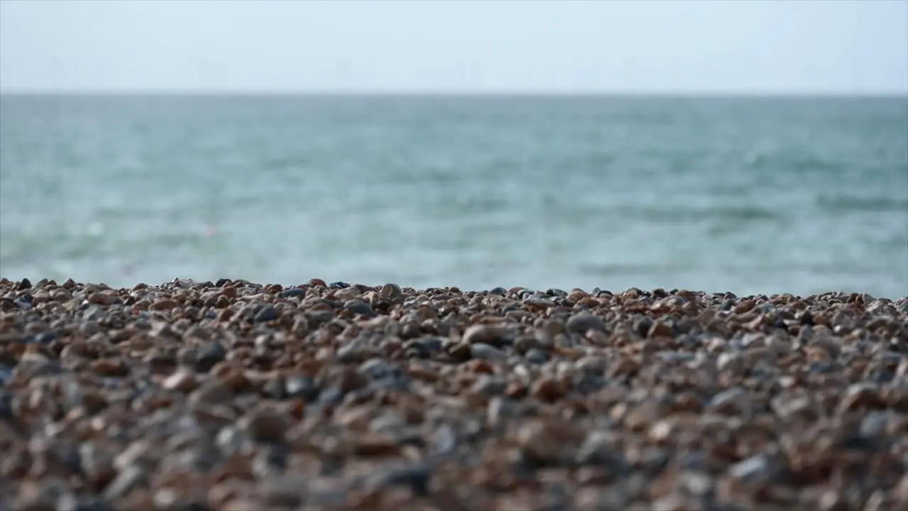 tilt up pebbles on a brighton beach sussex united kingdom english channel on the horizon