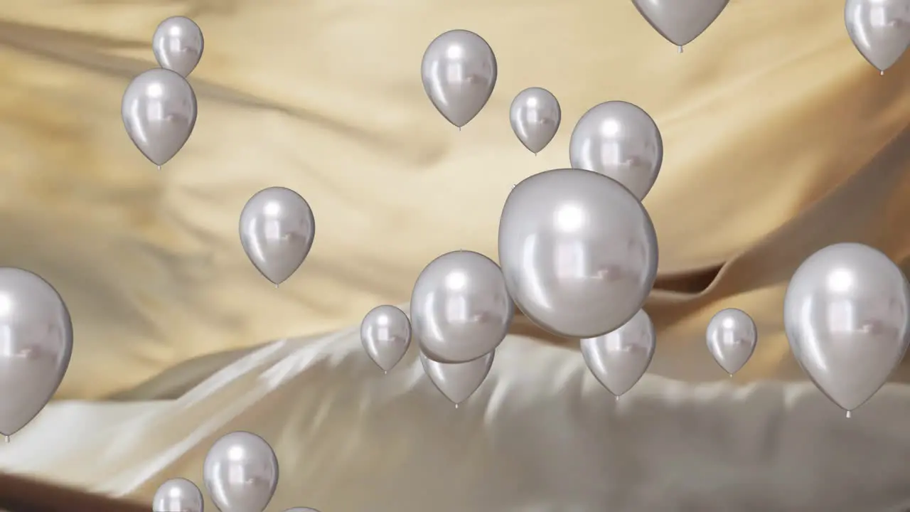 Animation of silver balloons floating over gold and black background