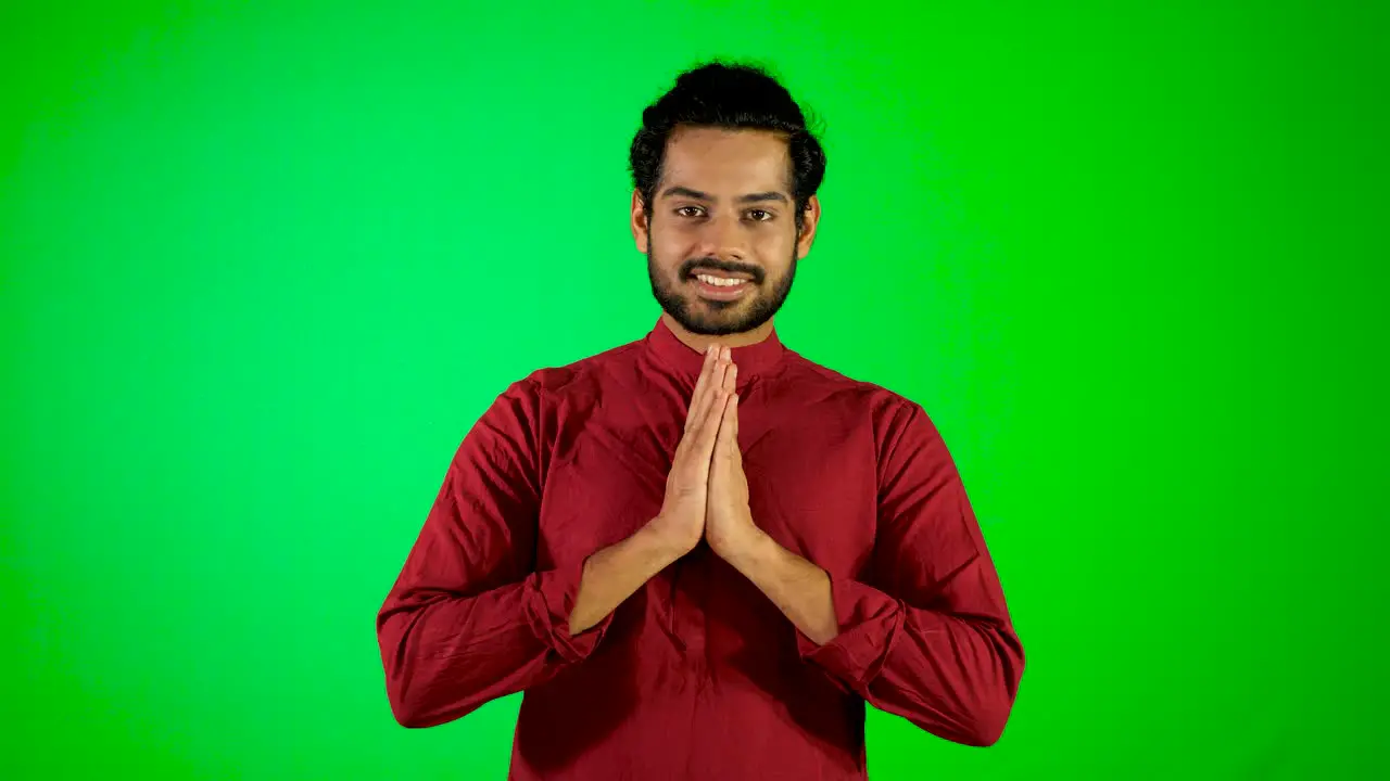 Indian guy namaste with green screen green background chroma key