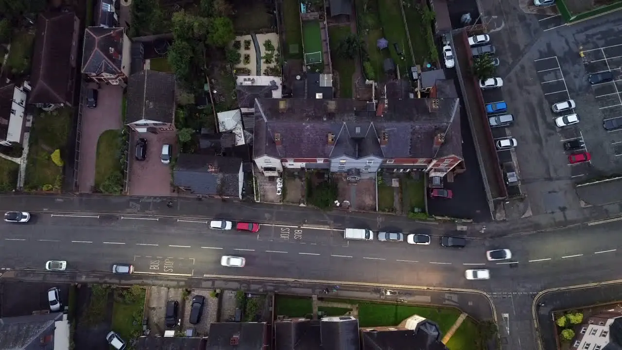 Aerial footage of a street at night in a typical British town