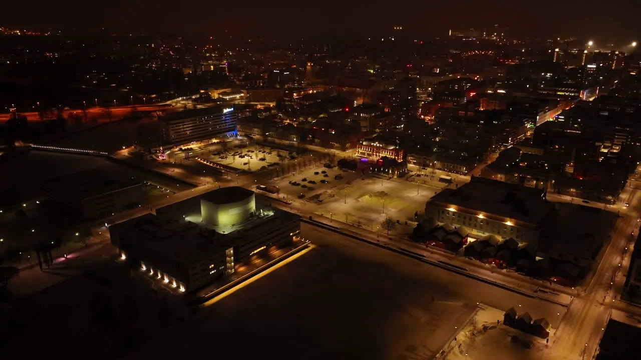 Aerial view around the illuminated market square of Oulu winter evening in Finland