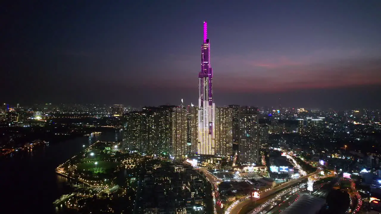 aerial orbiting beautiful and modern Landmark 81 Skyscraper building in Ho Chi Minh City Vietnam at night