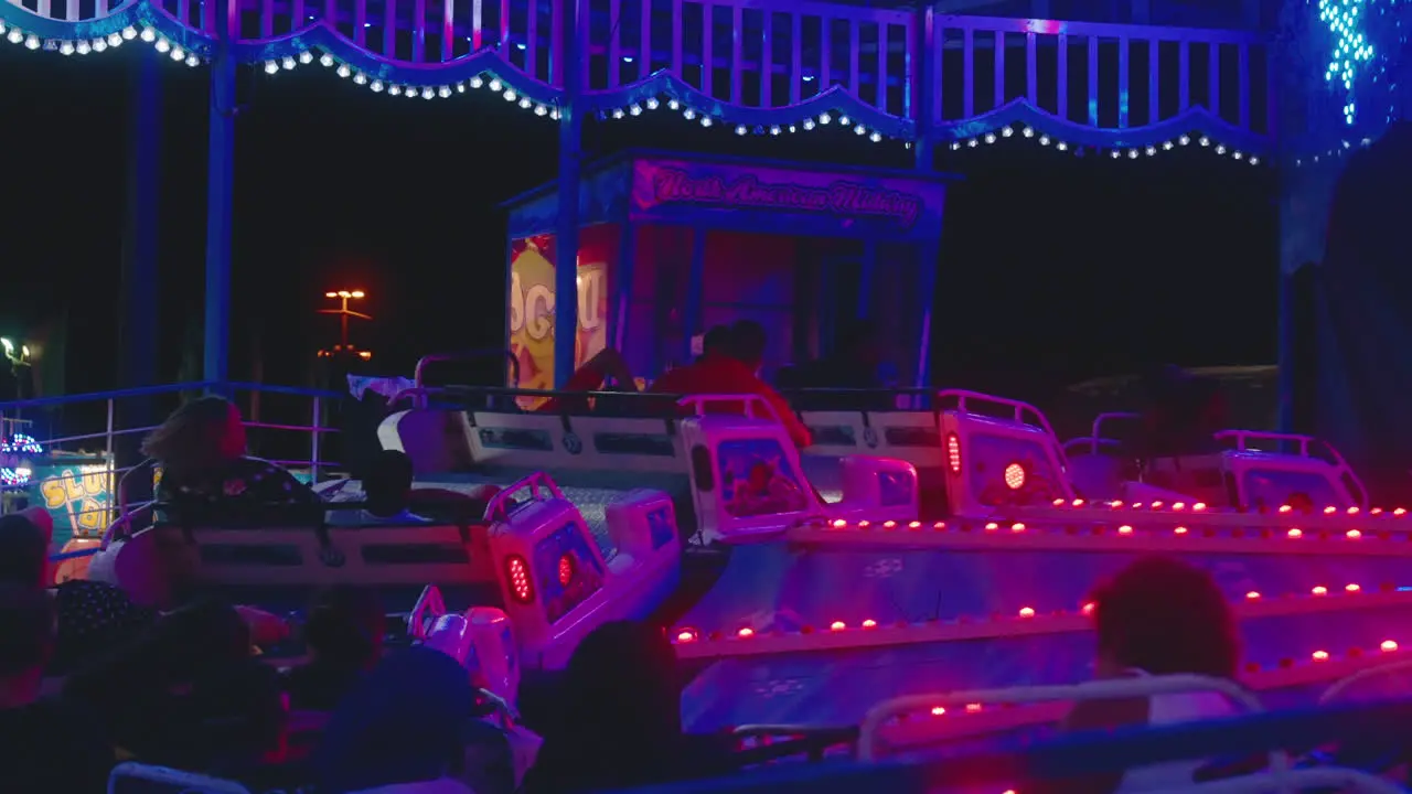 Lights flash as people enjoy the excitement of a carnival ride on a summer evening at the fair